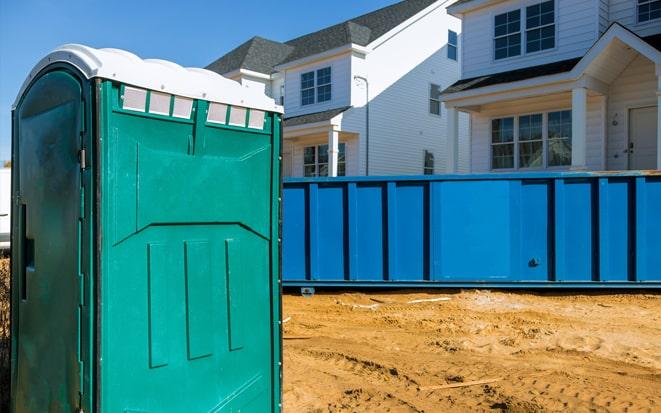 portable toilet and dumpster at a construction site in Lenexa KS